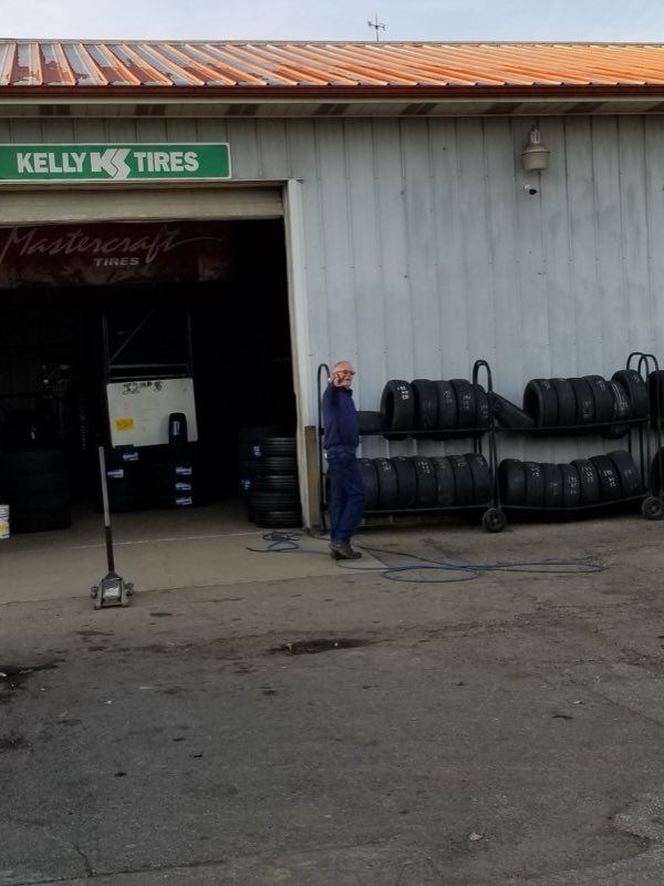 Open service bay with racks of tires at 32nd Street New and Used Tire