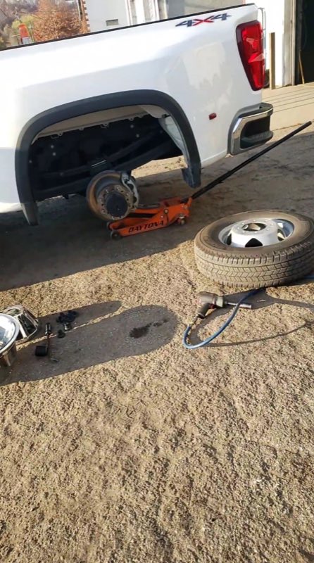 A tire being changed on a lifted 4x4 truck at 32nd Street New and Used Tire