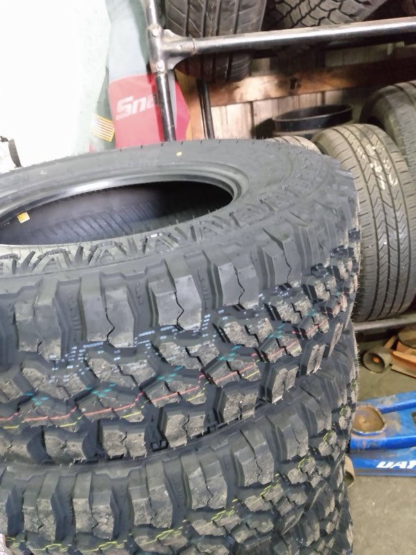 Close-up of aggressive off-road tire tread in stock at 32nd Street New and Used Tire